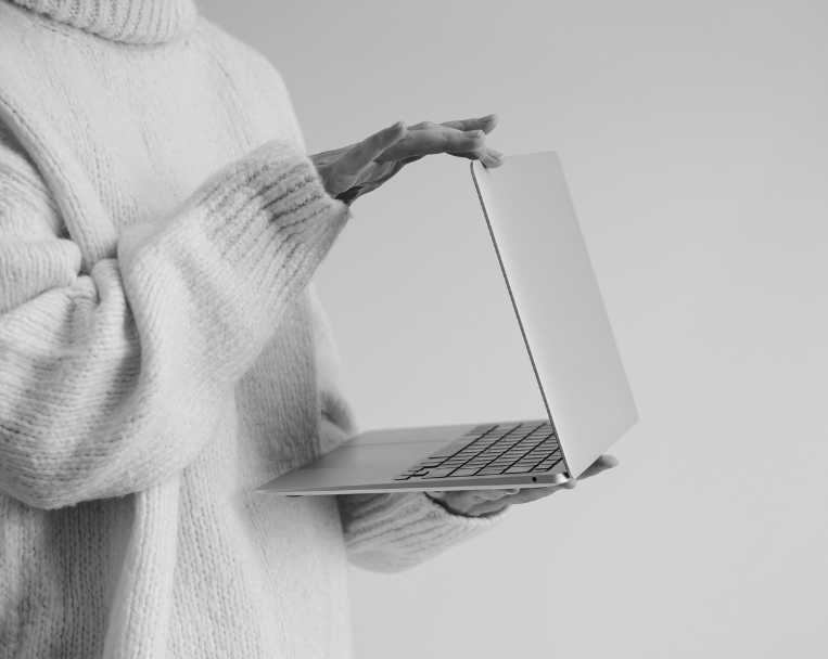 Closing laptop after completing marketing work for a small business client